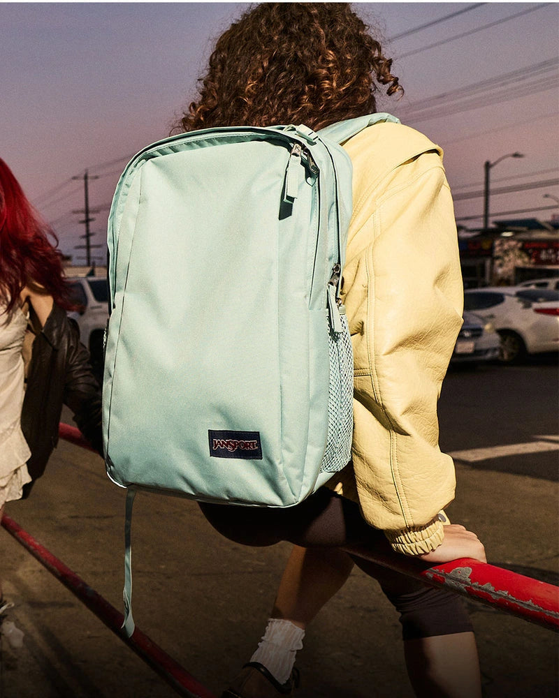 Mint JanSport backpack worn outdoors